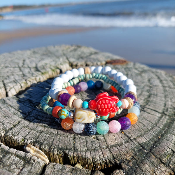 Handcrafted Collection of 3 Wood &amp; Stone Beaded Bracelets  Each Bracelet is individually designed, (1) 8mm white natural wood &amp; purple, peach &amp; turquoise stone beads, coconut discs, &amp; orange ceramic turtle (2) 6mm multicolour crackle natural stone beads plus (3) 4mm aqua wood beads with stone discs &amp; silver plated hematite beads  Elasticated, so will fit most adult wrists (measuring 7.5 in/19cm)