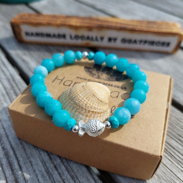 Gorgeous 8mm Sea Blue Matt Beads with Sterling Silver Beads &amp; Cute Fish Charm  Elasticated, so will fit most adult wrists (measuring 7.5 in/19cm)   Add a cool beach vibe look to your outfit&nbsp;  **Presented in lovely Kraft paper gift box with reusable organza pouch**