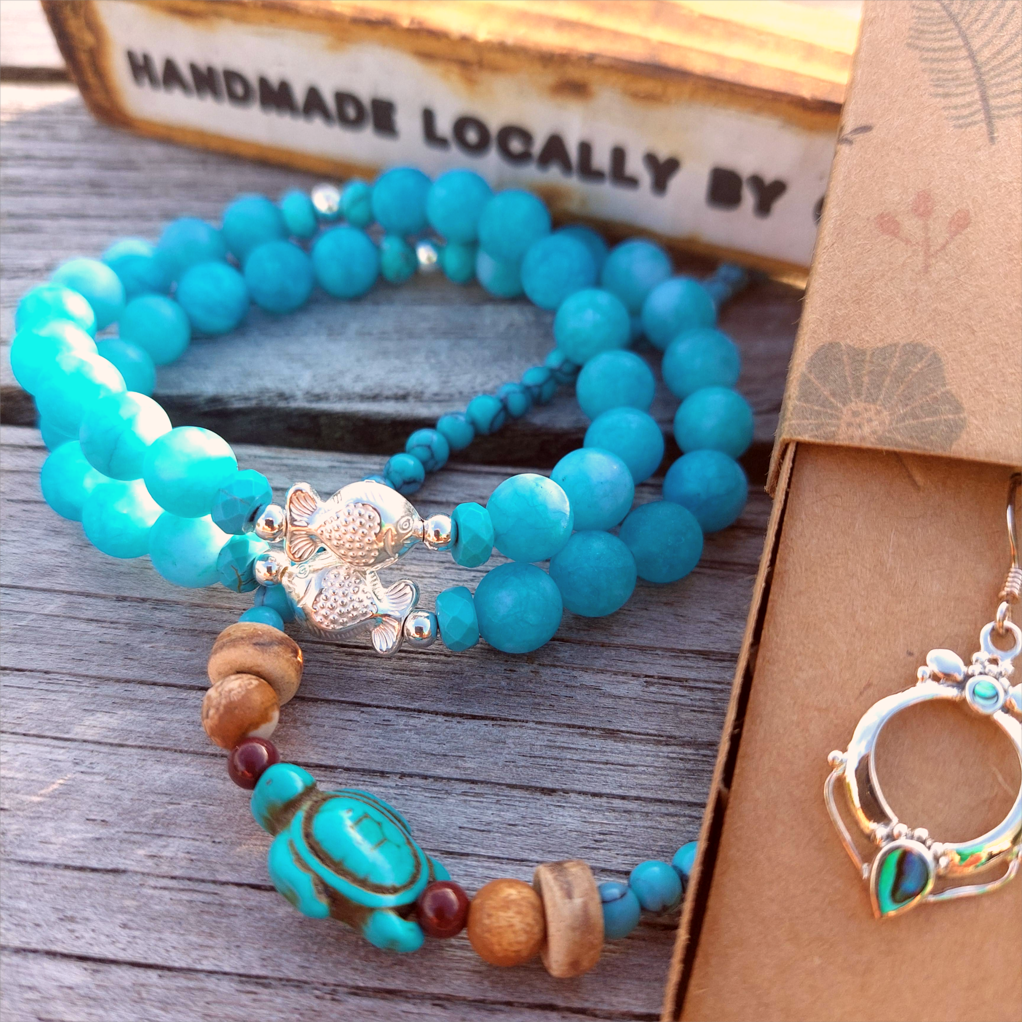 Gorgeous 8mm Sea Blue Matt Beads with Sterling Silver Beads &amp; Cute Fish Charm  Elasticated, so will fit most adult wrists (measuring 7.5 in/19cm)   Add a cool beach vibe look to your outfit&nbsp;  **Presented in lovely Kraft paper gift box with reusable organza pouch**