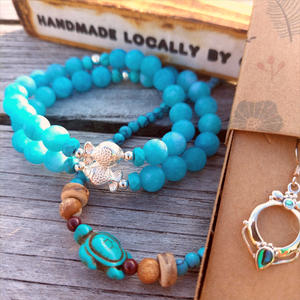 Gorgeous 8mm Sea Blue Matt Beads with Sterling Silver Beads &amp; Cute Fish Charm  Elasticated, so will fit most adult wrists (measuring 7.5 in/19cm)   Add a cool beach vibe look to your outfit&nbsp;  **Presented in lovely Kraft paper gift box with reusable organza pouch**