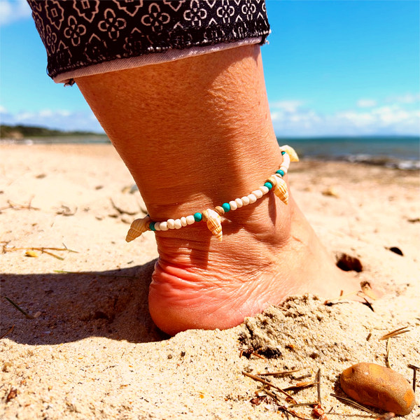 Ivory seed beads, turquoise calcite, coconut discs &amp; little spiral shells  Each anklet has gold plated fastenings &amp; lobster clasp with star charm  Length - 24cm extends to 251/2cm  Perfect gift for any surf chick!  **Presented in lovely Kraft paper gift box with reusable organza pouch**