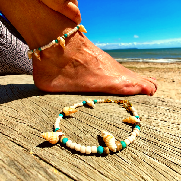 Ivory seed beads, turquoise calcite, coconut discs &amp; little spiral shells  Each anklet has gold plated fastenings &amp; lobster clasp with star charm  Length - 24cm extends to 251/2cm  Perfect gift for any surf chick!  **Presented in lovely Kraft paper gift box with reusable organza pouch**