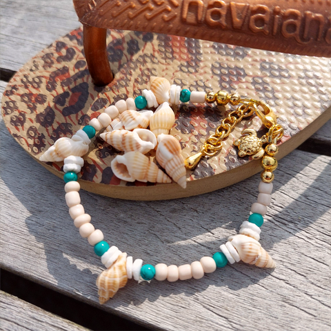 Gorgeous delicate bracelet, great for stacking or wear alone for a beach look!  Ivory seed beads, turquoise calcite, puka shells &amp; little spiral shells  Each bracelet has gold plated fastenings &amp; lobster clasp with super cute turtle charm &amp; extension chain  Lenght 20cm extending to 23cm&nbsp;  Perfect gift for any surf chick!