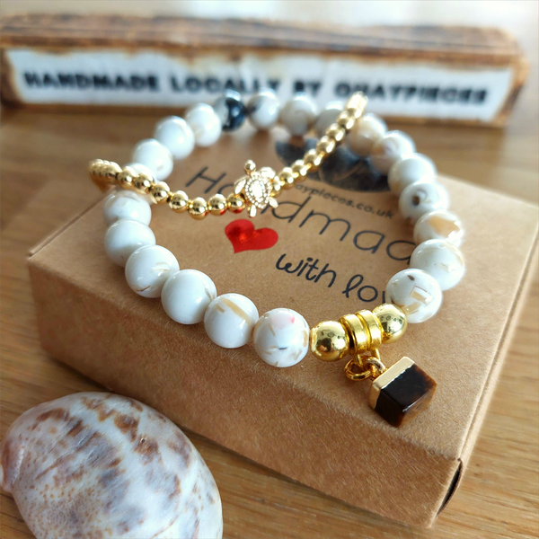 Lovely cream marble effect 8mm stone beads with coffee colour stone cube &amp; gold plated hematite beads.

Each bracelet will be unique due to varying colour shades of the stone beads

Elasticated, so will fit most adult wrists (measuring 71/2 in/19cm)

**Presented in lovely Kraft paper gift box with reusable organza pouch**